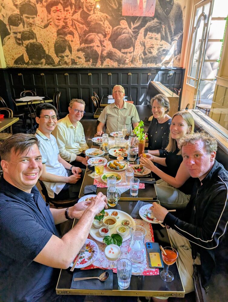 A guide and guests around a long table sharing lunch at a Melbourne restaurant