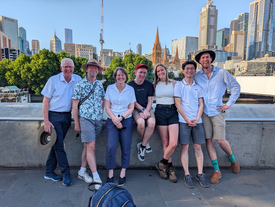 A tour group on Southbank with the city skyline behind them